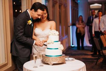 Sweet Couple Sharing Their First Slice - Photo Courtesy of Hewitt Photography